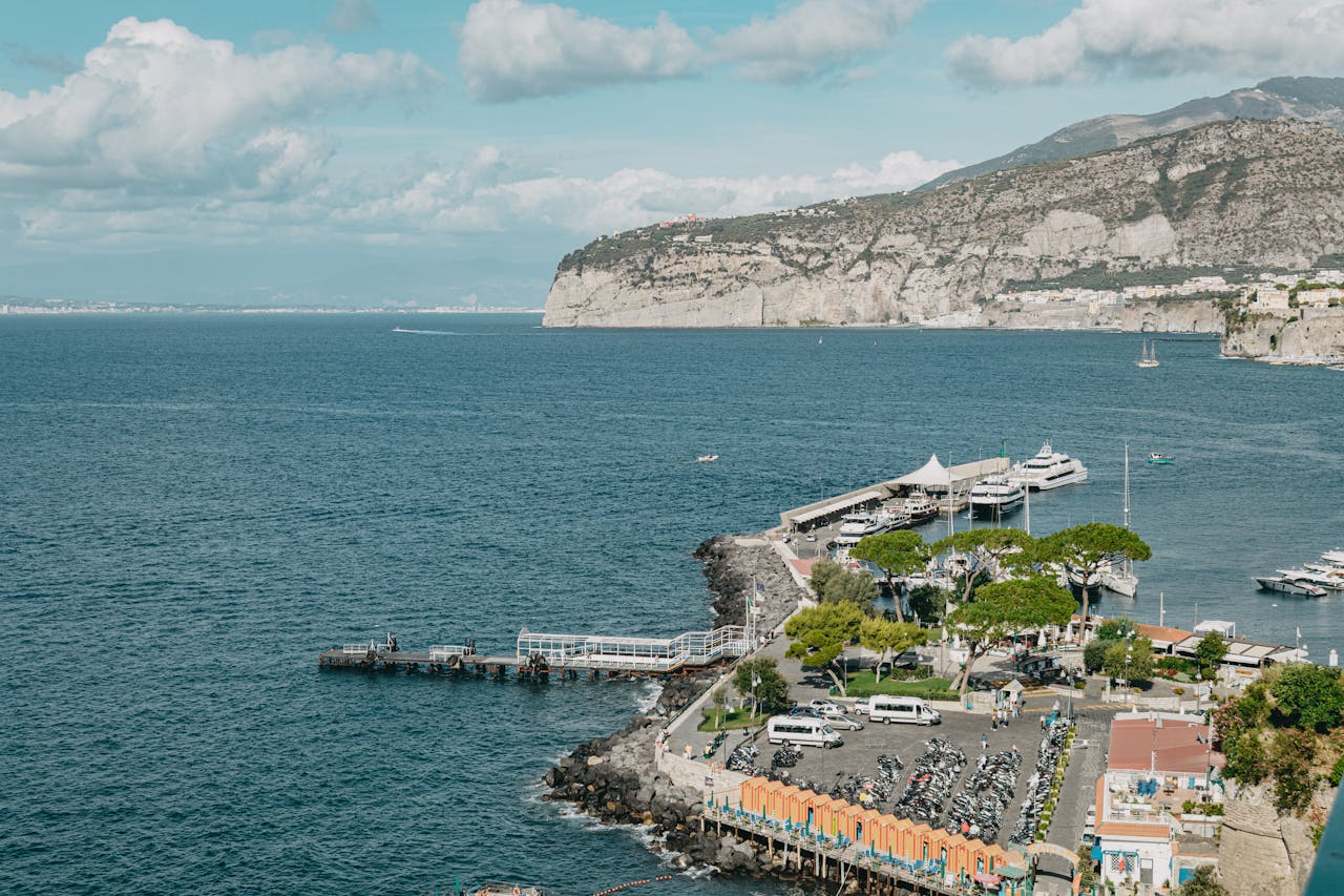 Aerial shot of the picturesque Sorrento coastline with clear skies and calm seas.
